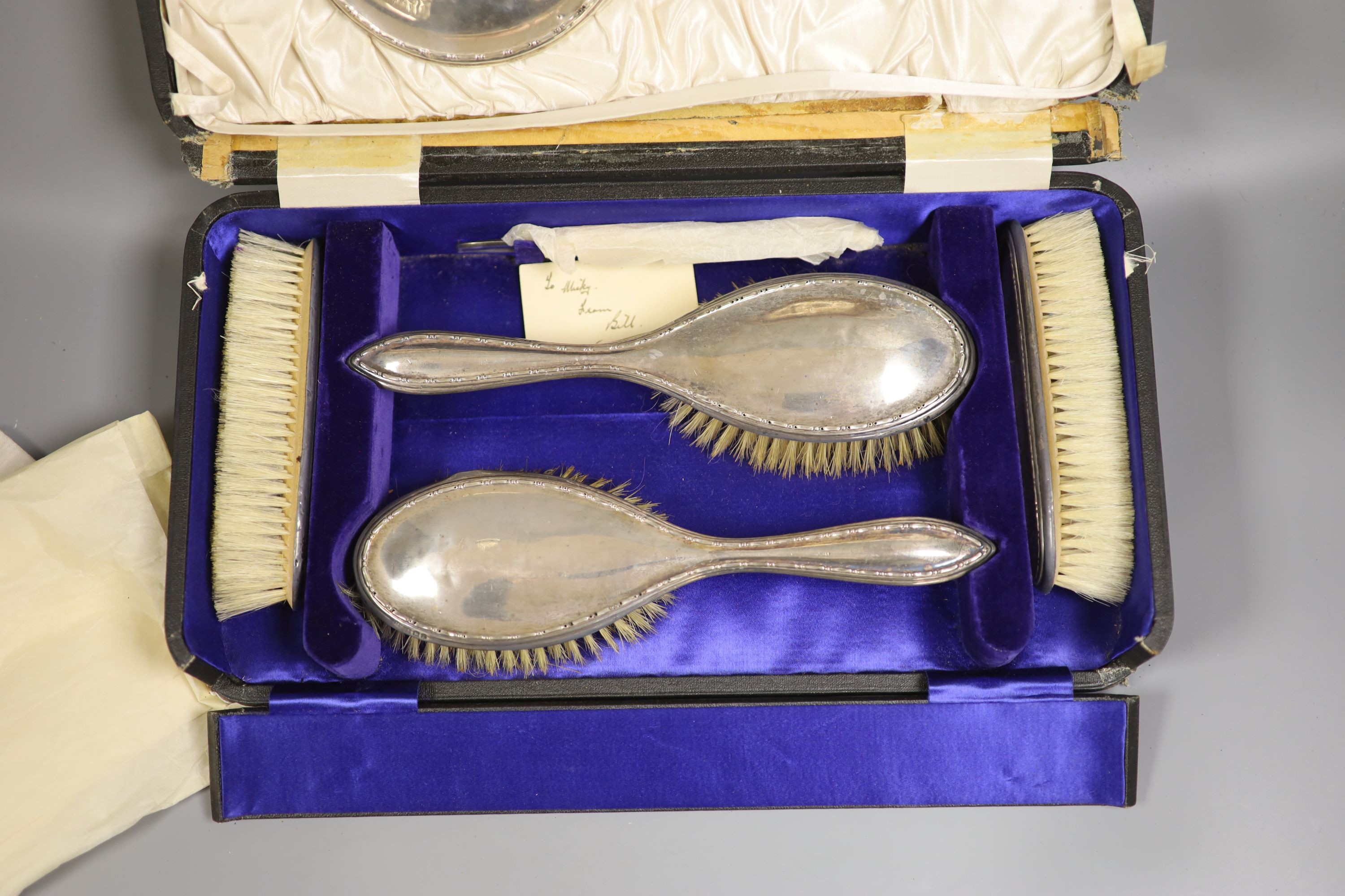 A cased George V six piece mirror and brush set.